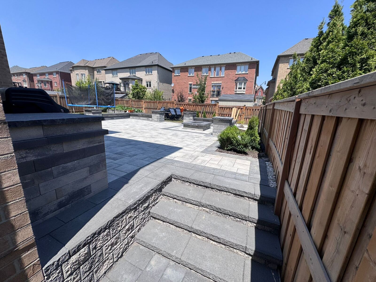 Premium stone patio with natural landscaping